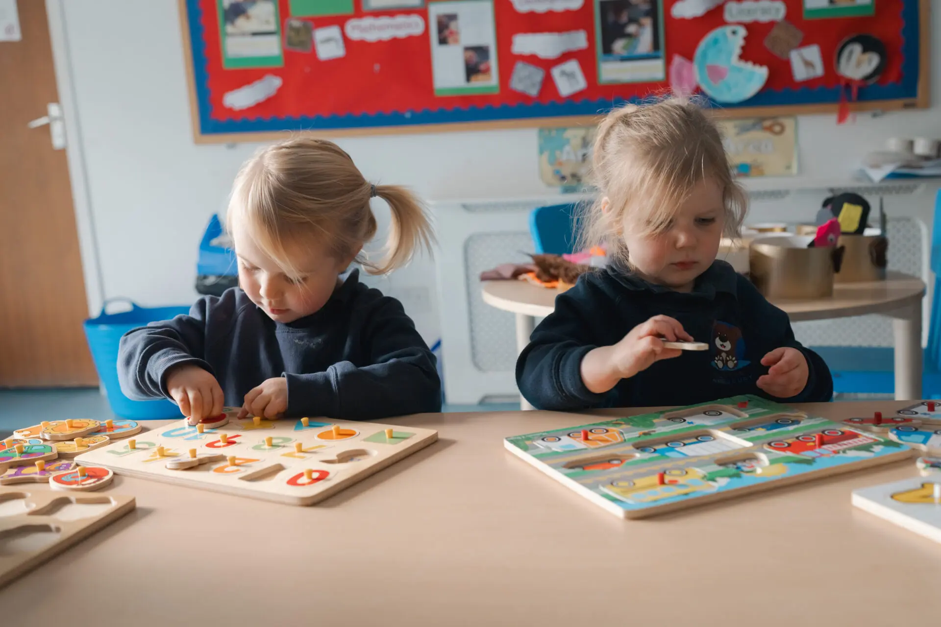 Image of Little Amesbury pupils playing with wooden toys