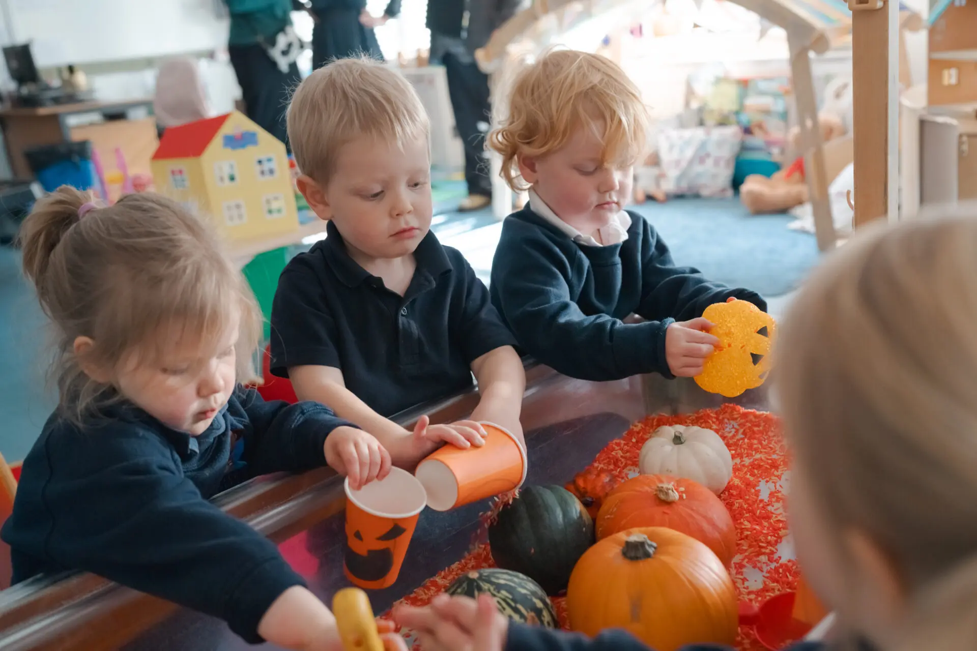Little Amesbury pupils playing with cups and pumpkins Image of Little Amesbury pupils playing with cups and pumpkins