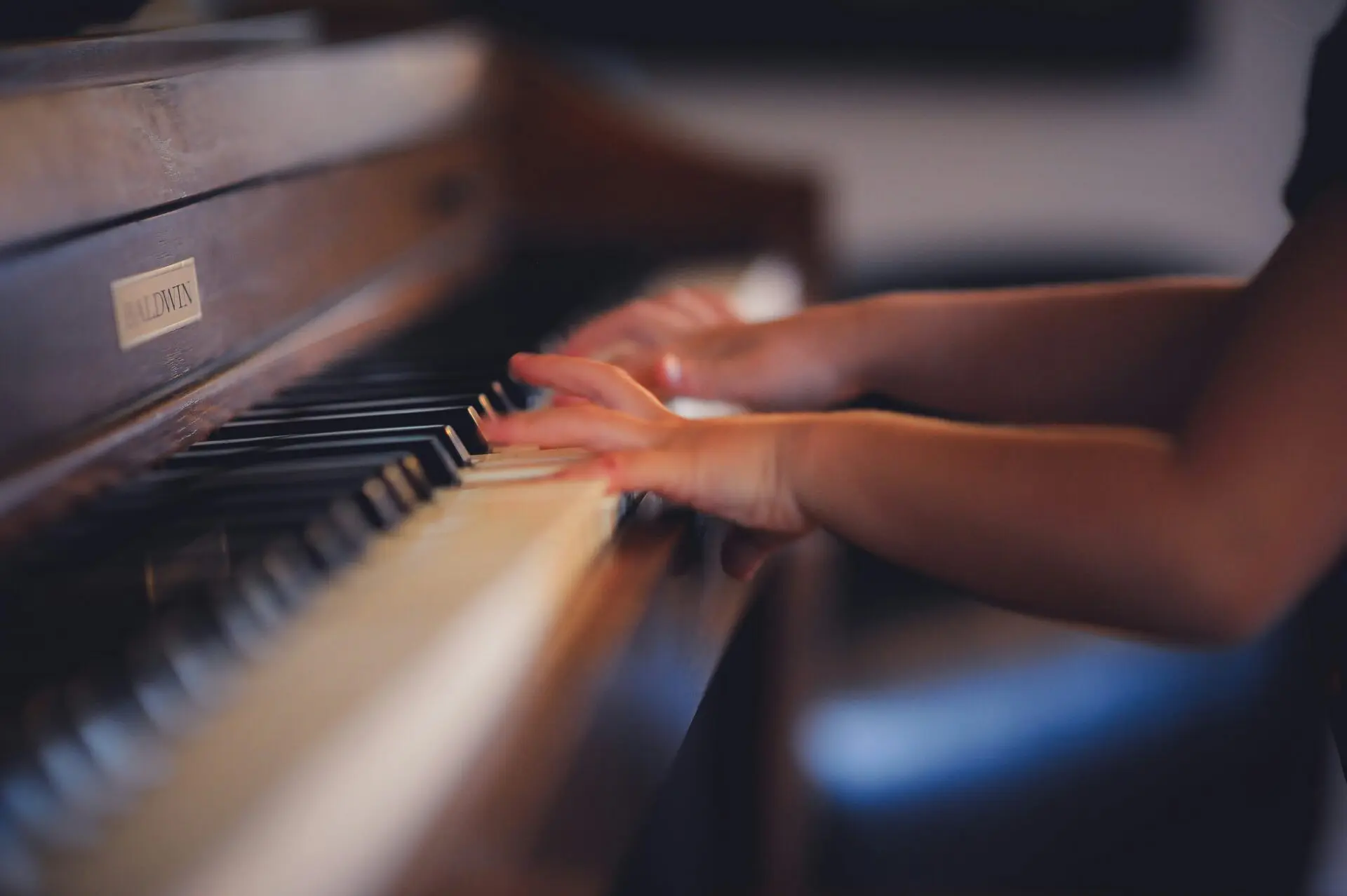 A pupils hands playing piano Image of a pupils hands playing piano