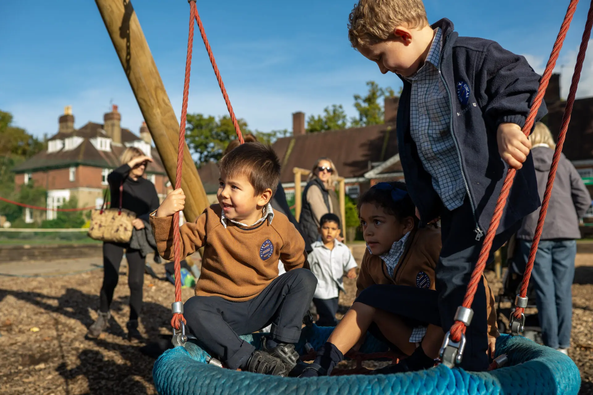 Pre-prep students playing on a tire swing an image of pre-prep students playing on a tire swing