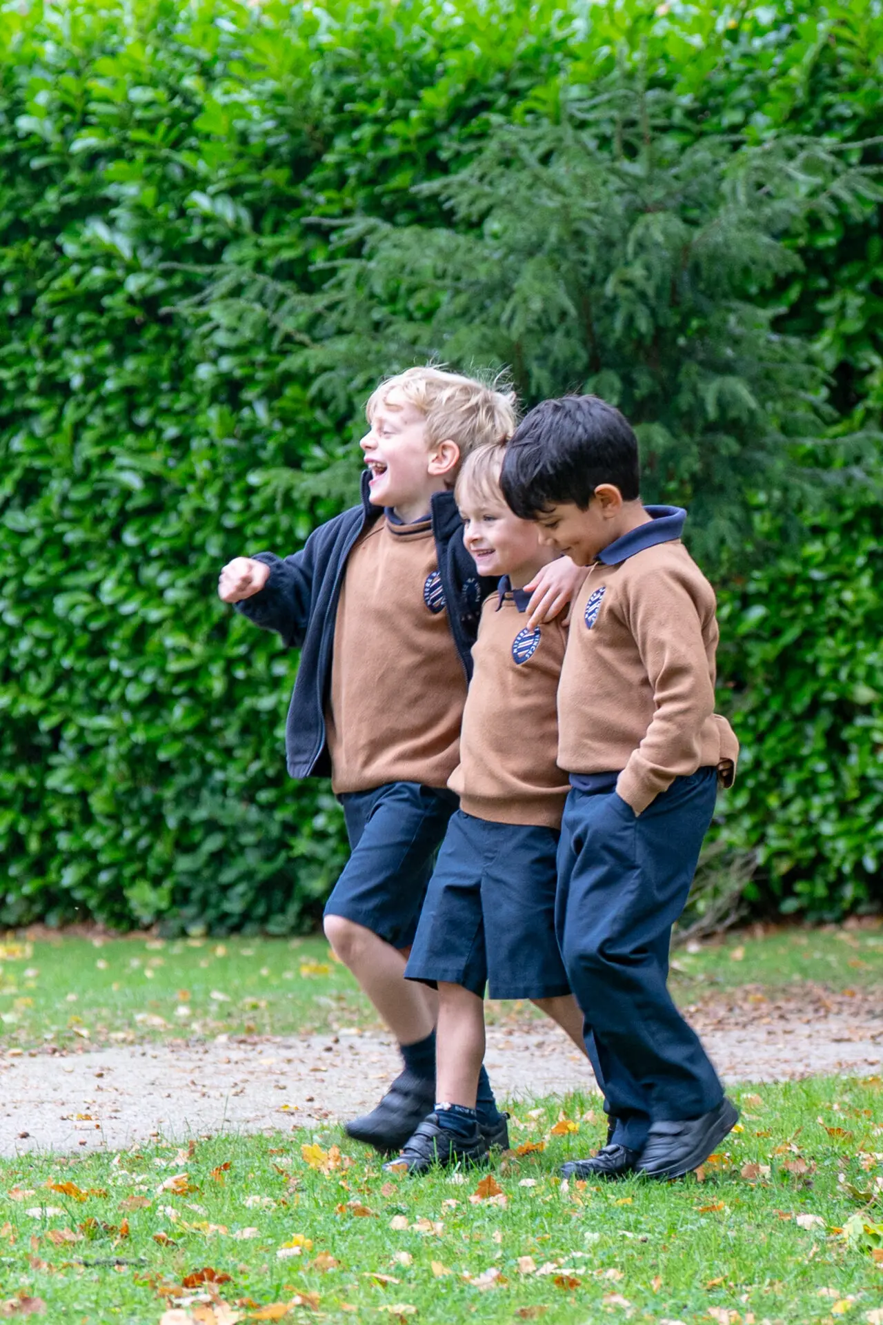 an image of pre-prep students playing on a tire swing