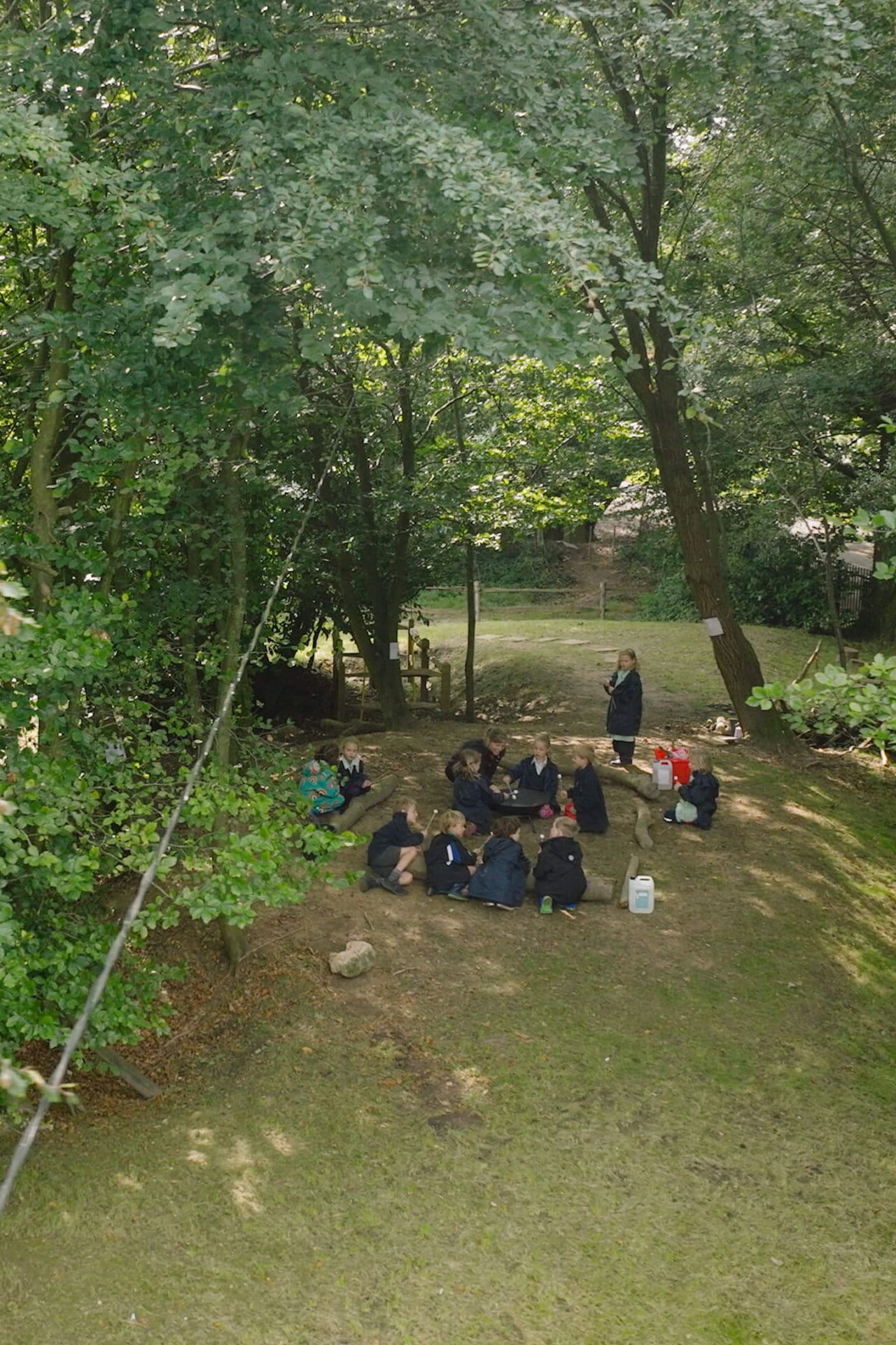 Image of pupils taking part in a holiday club in the woods