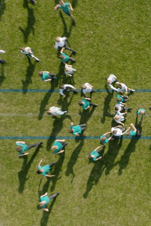 Birds-eye view of the sports field with children playing